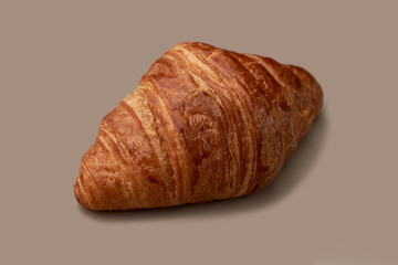 lush croissant on beige background