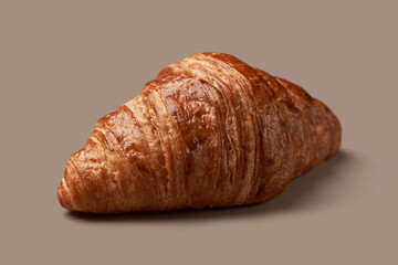 lush croissant on beige background