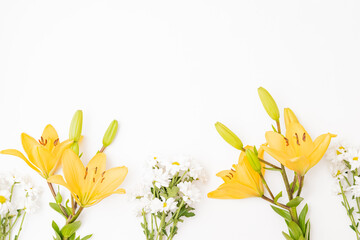 Fototapeta na wymiar Flat lay frame with yellow lilies on white background