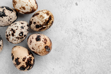 Flat lay composition with quail eggs on white background, space for text and closeup