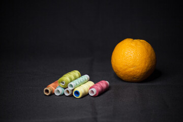 Spools of colorful thread with an orange