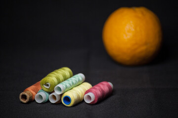 Spools of colorful thread with an orange