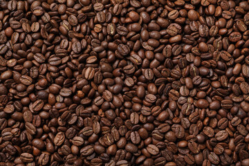 Pile of roasted coffee beans as background, top view