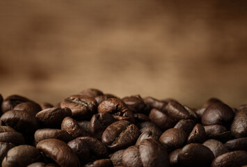 Heap of aromatic roasted coffee beans, closeup