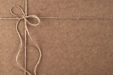gift packaging made of craft paper, tied with a jute rope with a bow