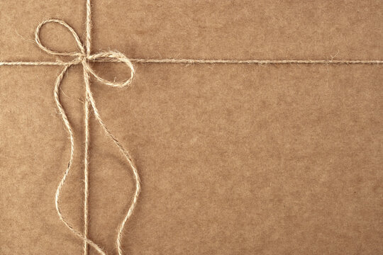 gift packaging made of craft paper, tied with a jute rope with a bow