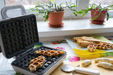 Croffles are waffles made of puff pastry, baked in an electric waffle iron. Next to the raw dough...
