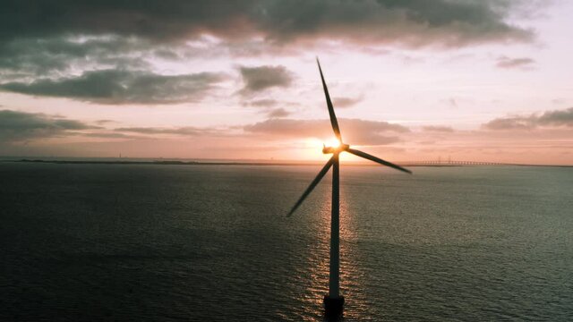 Windmills of shore jn sunrise
