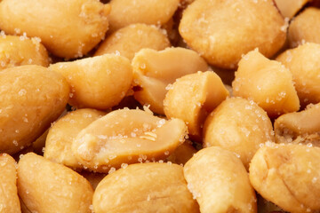 Closeup of salted peanuts, salty snacks background