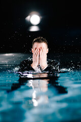 Man in black suite swimming in a pool. business man having fun in a pool. Office Worker drowing and...