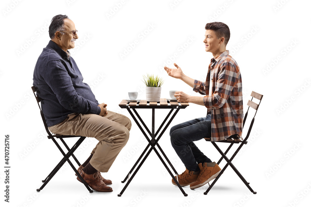 Poster Young man talking to a mature man and sitting in a cafe