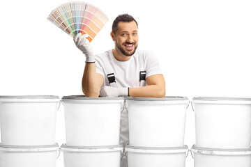 House painter leaning on a pile of buckets and holding a color palette
