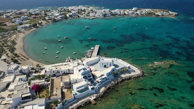 Aerial drone rotational video of picturesque fishing village of Polonia with traditional fishing boats anchored next to island of Kimolos, Milos island, Cyclades, Greece
