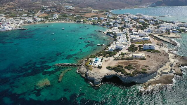 Aerial drone rotational video of picturesque fishing village of Polonia with traditional fishing boats anchored next to island of Kimolos, Milos island, Cyclades, Greece