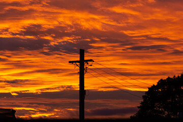 Electricity Power Lines silhouette into the sunset.  Renewable energy in New Zealand