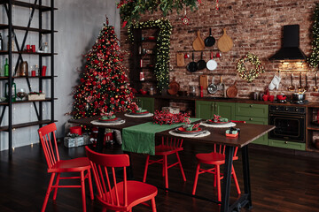 Christmas decorated kitchen interior with comfortable table; Christmas fir tree 