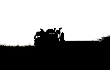 Fototapeta premium Silhouette of a British army soldier navigating from the cabin roof of a MAN SV 8x8 EPLS truck on a military exercise, Wiltshire UK 