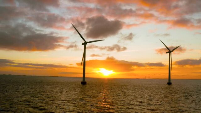 Windmills of shore jn sunrise