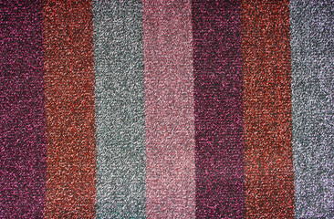 Striped red, violet, pink and silver shimmer fabric abstract background. Cloth texture.