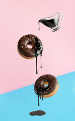 Flying donuts with dripping chocolate on pink blue background. Pop art design