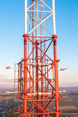 Fototapeta na wymiar Telecommunication tower with antennas on blue sky background