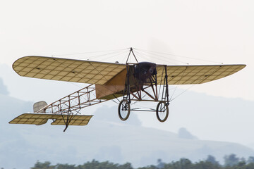 Historic airplane replica Bleriot XI in the air 