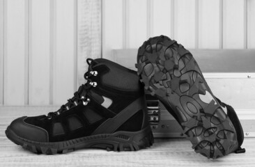 Close-up pair black textile work boots for safe winter with steel cap,boot view of non-slip...