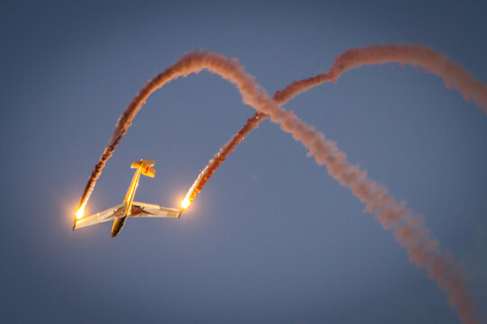 The austrian glider aerobatics team Blanix performing a beautiful display at an airshow during sunset and dawn