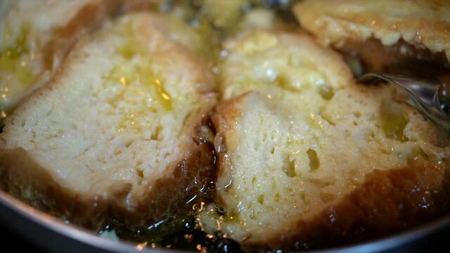 Frying bread to make"Rabanadas" (French Toasts) for Christmas