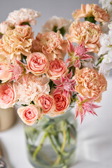 Finished flower arrangement in a vase for home. Flowers bunch, set for interior. Fresh cut flowers for decoration home. European floral shop. Delivery fresh cut flower.