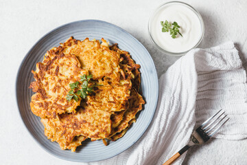 Potato pancakes Latkes on white table background. Traditional Jewish festive food for Hanukkah holiday. Jew festival of lights. Flat lay, top view