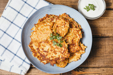 Potato pancakes Latkes on wooden table background. Traditional Jewish festive food for Hanukkah holiday. Jew festival of lights. Flat lay, top view