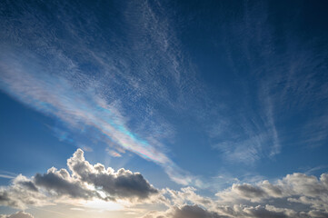 Cirrocumulus undulatus clouds with iridescent spectral colors by reflection or refraction, an...