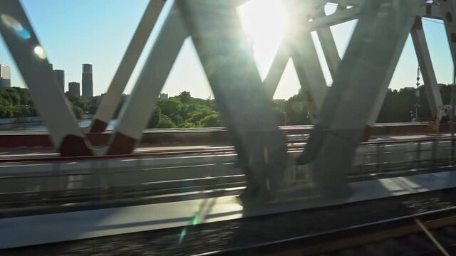 View from the window of a train moving across the river on the railway bridge