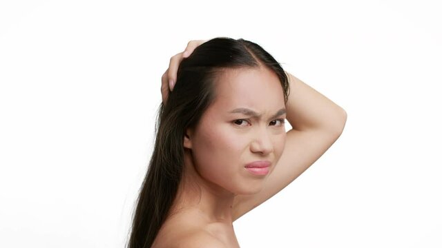 Asian Female Touching Weak Brunette Hair Posing Over White Background