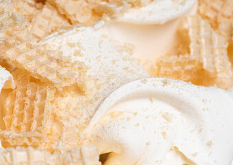 Frozen Creamy flavour gelato (called Russian Ice Cream) - full frame detail. Close up of a white surface texture of Ice cream covered with pieces of broken waffle.