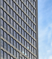 Modern office building against a blue sky.	