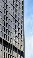 Modern office building against a blue sky.