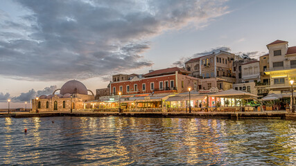 the mosque and restaurants in the venetian harbour of Chania in the first morning glance