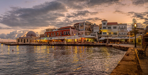 Fototapeta premium the mosque and the harbour in Chania at the first morning light with reflections in the sea