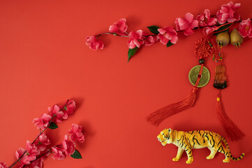 Chinese New Year 2022 Spring Festival. Flat lay, Happy Lunar New Year of tiger.Traditional and modern concept red with cherry flower. Asian elements.