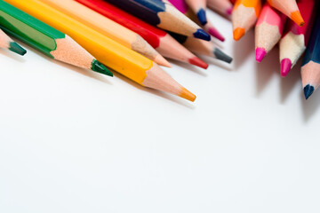 Lots of multi-colored pencils on white paper.
