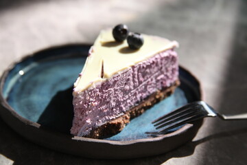 a piece of fruit cake is ready to be eaten on plate. It looks very delicious. 