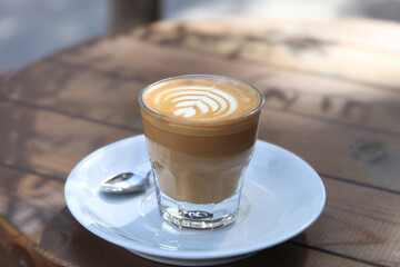 Professional latte art pattern. Coffee being served. People have coffe break.