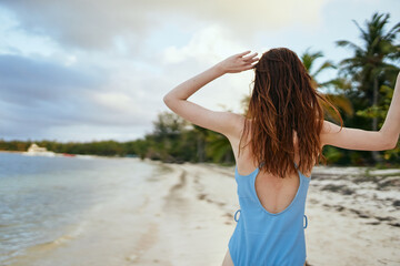 Fototapeta na wymiar woman in blue swimsuit on the beach island lifestyle