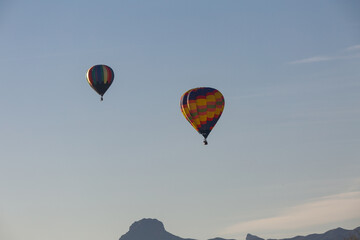 two hot air balloons flying in the Arizona sky 