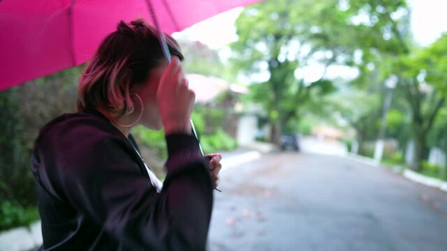 Woman opening umbrella outside during drizzle day