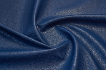 Fototapeta premium blue artificial leather with waves and folds on PVC base