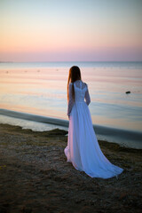 Fototapeta na wymiar bride on the beach at sunset
