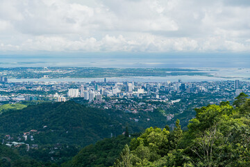 Fototapeta na wymiar Aerial view of Cebu cityscape with trees. Landscape view from top mountain.